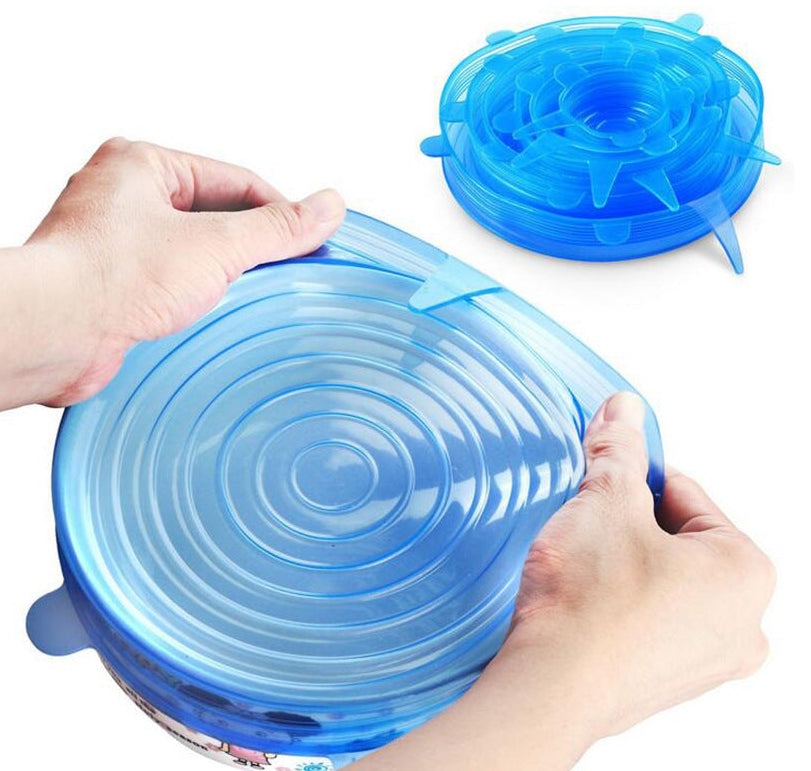 Blue silicone lid being stretched over a container by hands on a white background