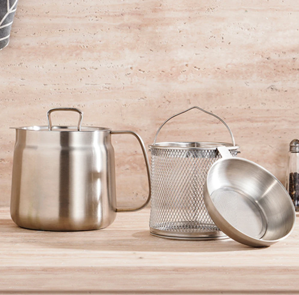 Set of stainless steel kitchen utensils including a pot, strainer, and ladle on a wooden surface.